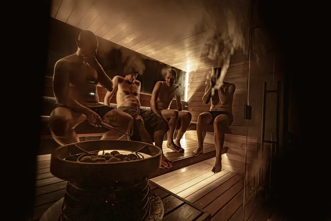 Person relaxing in traditional wooden sauna with steam rising, demonstrating daily sauna benefits for wellness and health res