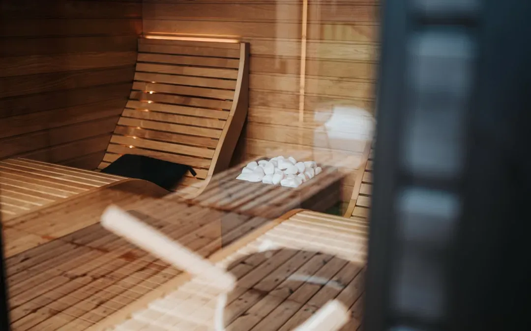Traditional Finnish sauna interior with wooden benches, glowing heated stones, and gentle steam demonstrating safe beginner s